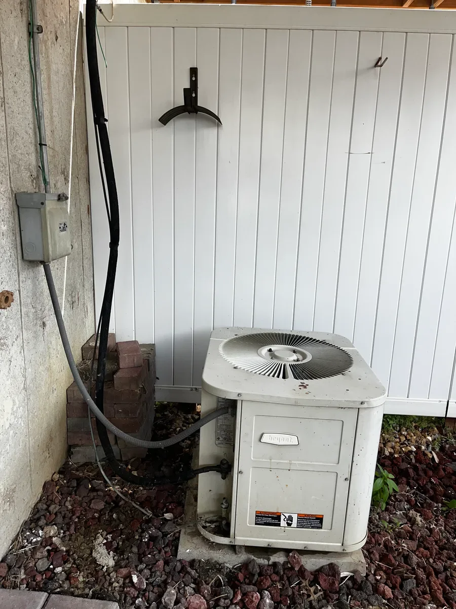 Outdoor heat pump before replacement in O'Fallon, Missouri.