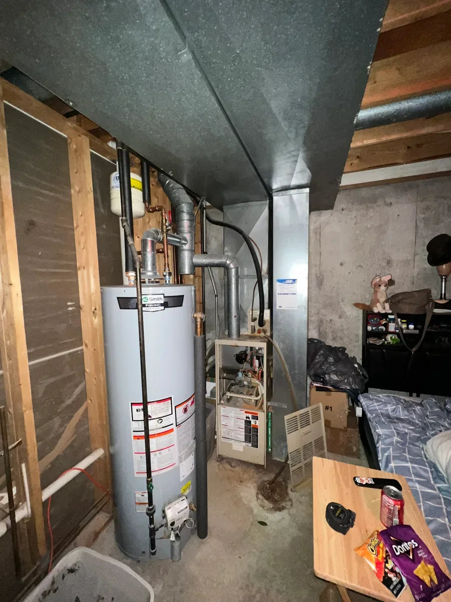 Indoor furnace before a complete heating and cooling system replacement in O'Fallon, Missouri.