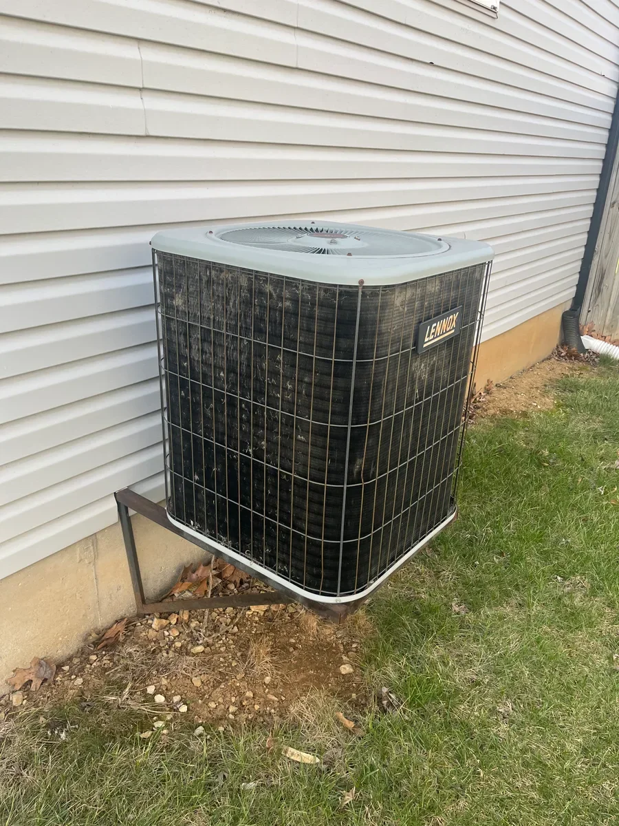Outdoor air conditioner before a complete heating and cooling system replacement in O'Fallon, Missouri.
